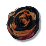 Multicolored scarf with black, orange, and red pattern on a white background