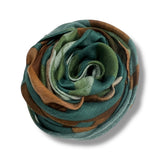 Rolled-up scarf with green and brown tones on a white background